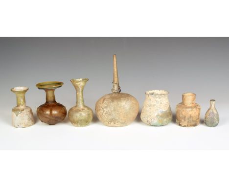 A Roman glass scent flask, with tapering neck and blue glass applied trail, 18cm high, three glass flasks with cylindrical ne