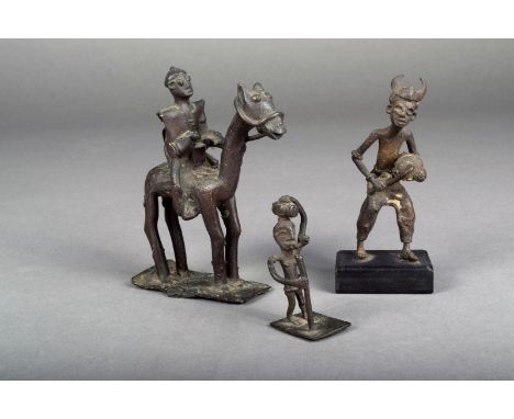 An Ashanti brass gold weight, of a standing figure smoking a pipe with a keg of gunpowder on his head, 6.5cm high, an Ashanti