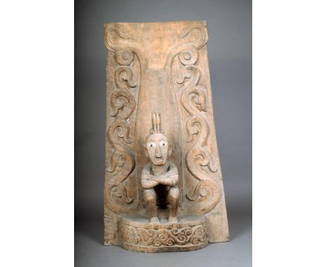 A Leti panel, Indonesia, with a relief carved tendril back and a seated male figure, with inlaid bone eyes, 88.5 x 49.5cm.