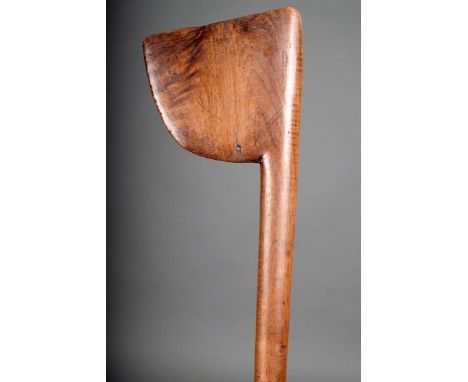 A Maori tewhatewha, with axe shape blade with a pierced hole at the base with an eliptical shape shaft and raised bands and t