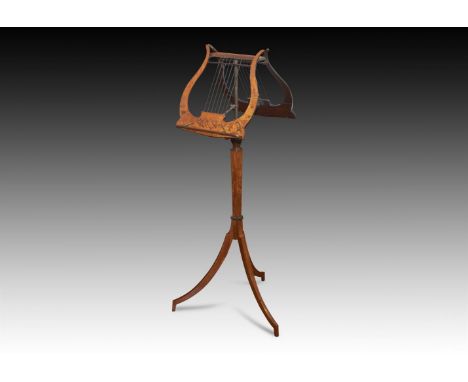†  A SATINWOOD, MAHOGANY AND MARQUETRY INLAID DUET STANDCIRCA 1900The hinged lyre rests on a tapering hexagonal column and tr