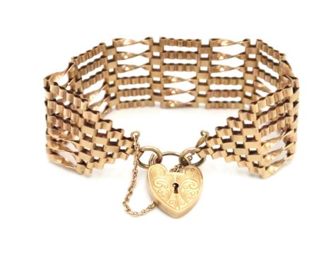 A 9ct gold gate bracelet with engraved padlock clasp. Weight  29.52 grams.
