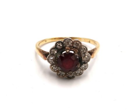 A garnet cluster ring with old and single cut diamond surround. Size S 1/2. Tests gold 18ct. Weight 3.66 grams