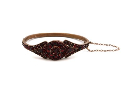 A 19th century garnet set bangle, on rolled gold, internal diameter, 49 by 61.6mm, 17.1g total weight.