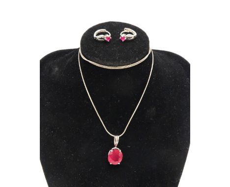 A 9ct white gold and ruby pendant, the oval stone of approximately 11.0 by 12.2mm, likely glass filled, 2.3g, with silver cha