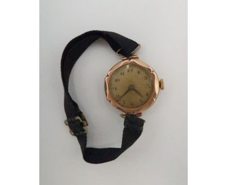 A lady's, 9ct gold cased, vintage watch, the sunburst engraved dial with Arabic numerals, minute track and blued hands, on bl