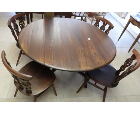A dark Ercol elm drop flap dining table and four matching Ercol chairs, table 106cm wide x 72cm high x 123cm deep when extend