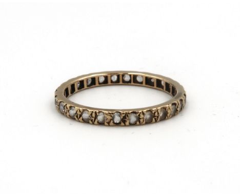 A 9ct gold and white stone eternity ring, size R, 1.6g.
