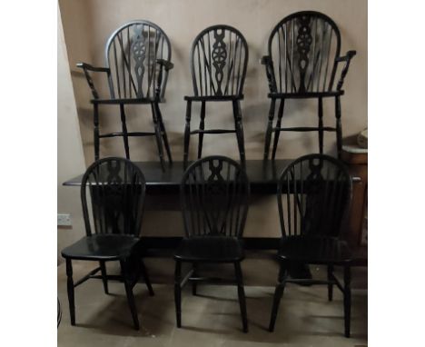 Ercol dining table plus six (4+2) wheel back chairs. 