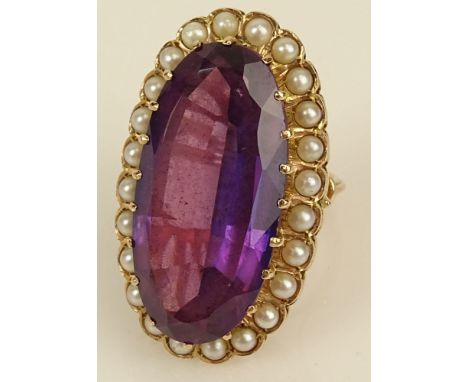 Lady's vintage large oval cut amethyst, seed pearl and 14 karat yellow gold ring. Amethyst measures 32mm x 16mm. Signed 14. G