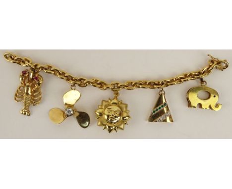 Lady's vintage 18 karat yellow gold charm bracelet with four 14 karat yellow gold charms and one 18 karat yellow gold charm. 