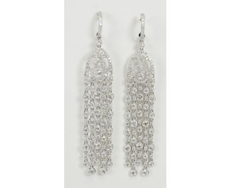 Pair of lady's approx. 5.0 carat round cut diamond and 18 karat white gold chandelier earrings. Diamonds E-F color, VS clarit