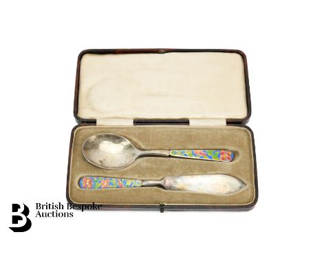 A George V silver and enamel preserve spoon and knife set, decorated with floral enamel handles, by Bernard Instone, hallmark