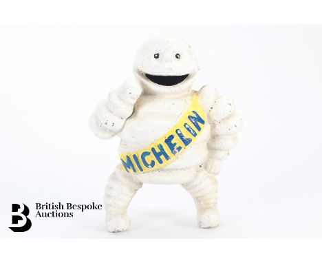 A cast iron Michelin Man money box, depicting Monsieur Bibbendum, the Michelin Tyres mascot, with slot to insert copper 1d co