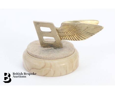 An unusual Bentley Flying B brass long service presentation mascot, awarded to a member of the Bentley engine assembly techni