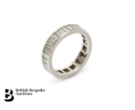 A diamond and platinum full eternity ring, set with approx. 2.4cts of baguette diamonds, size J, approx. 4gms.&nbsp;Condition