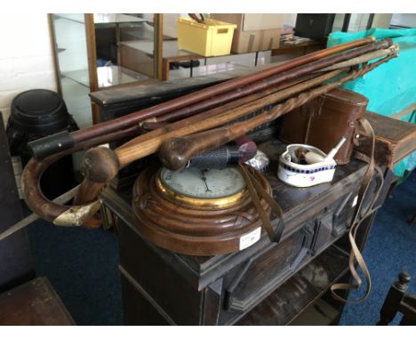 A collection of five walking canes together with a barometer, various pipes, a pair of binoculars etc.