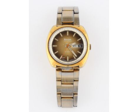 A gents Bulova gold plated wrist watch, the gold-tone dial having hourly baton markers with minute track border and day date 