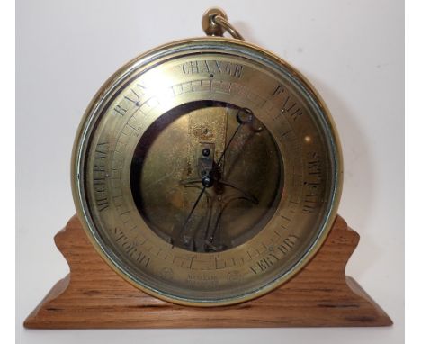 Unusual antique brass aneroid barometer with an oak stand