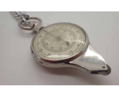 Compass and measure on a white metal chain
