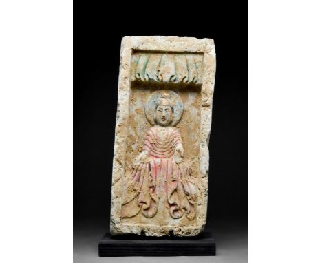 Ca. 386-534 AD A terracotta tile featuring a beautiful depiction of rendered in high relief a seated Buddha wearing rich garm