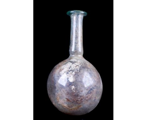 Ca. 1-100 AD A beautiful light-blue glass bottle with a spherical body and a tall tubular neck constricted at the base which 