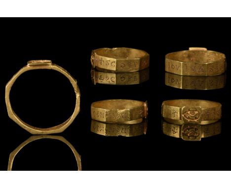 Ca. 1200 AD A rare gold finger ring comprised of a faceted band with a rectangular bezel carved with an IC monogram for Jesus