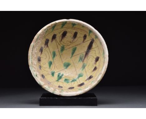 Persia, (Nishapur), Ca. 9th-10th century AD A pottery bowl of a conical form on a short unglazed foot. The interior is with c