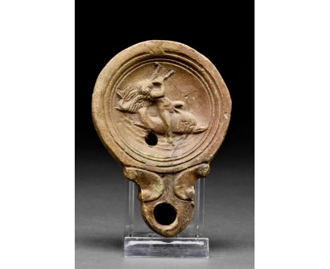 Ca. 1-200 AD A flat-bottomed terracotta oil lamp of Loeschcke type VIII, shoulder VIIIb. On the discus low relief figure of E
