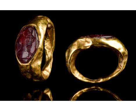 Ca. 100-300 AD A hollow gold ring composed of a round hoop with expanding shoulders and an oval bezel set with a carnelian in