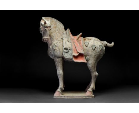Ca. 618-907 AD A beautiful pottery figure of a horse. The animal is shown in a standing pose on an integral base. The horse's