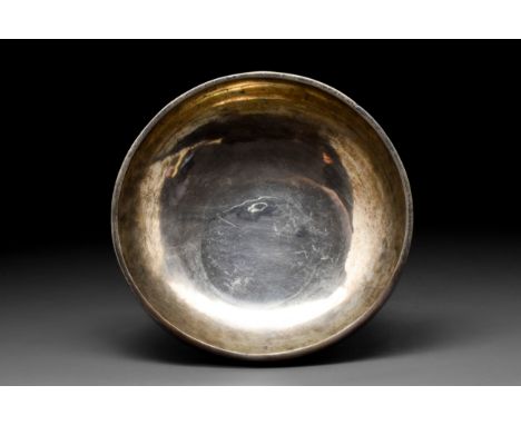 Ca. 224-651 AD A silver vessel comprising a deep hemispherical bowl on a wide flared foot. Bowls like this were used for pour