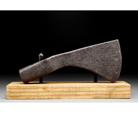 Ca. 900-1100 AD An iron axe head with a curved beard and cutting edge, narrow circular socket, and heavy hammer end. The blad