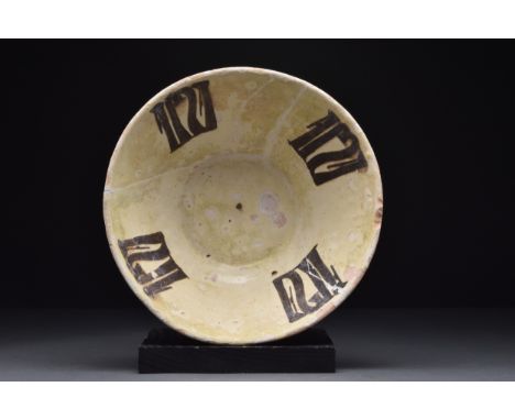 Nishapur, Ca. 10th century AD A nicely formed pottery bowl with its interior decorated with white tin glaze slip with black p
