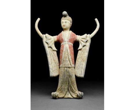 Ca. 618-907 AD A delicate female dancer wearing a long flowing gown with draped, winged sleeves. The long dress uncovers her 