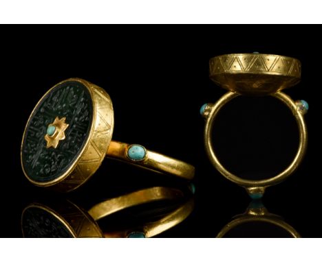 Ca. 1526-1858 AD A gold ring comprised of a round hoop with three cells, each set with a turquoise gem and an applied large b