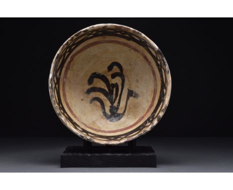 Persia, Nishapur, Ca. 10th century AD A ceramic bowl of hemispherical shape rising from a thick ring foot. The cream interior