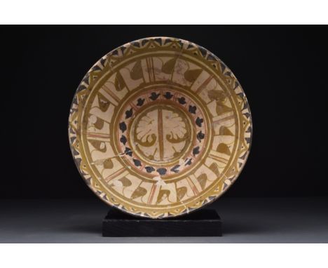 Egypt, Ca. 11th-13th century AD A ceramic bowl of a wide, flaring body sitting upon a low ring foot. The interior is highly o