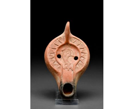 North Africa, Ca. 300-600 AD A beautiful terracotta oil lamp featuring a recessed discus with two parallel filling holes and 