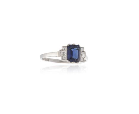 A SAPPHIRE AND DIAMOND RINGOf Art Deco style, the rectangular step-cut sapphire, within a six-claw setting, between square-cu