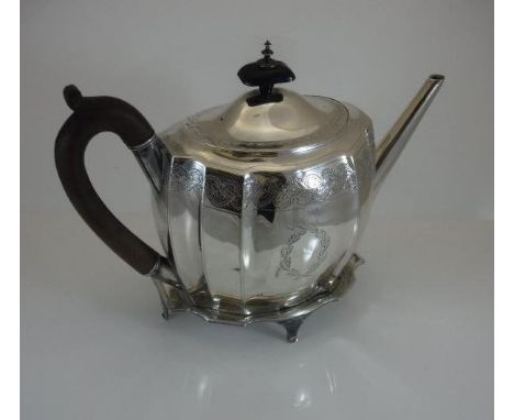 A George III silver teapot of rectangular bellied form and engraved floral decoration and ebonised handles, together with a m