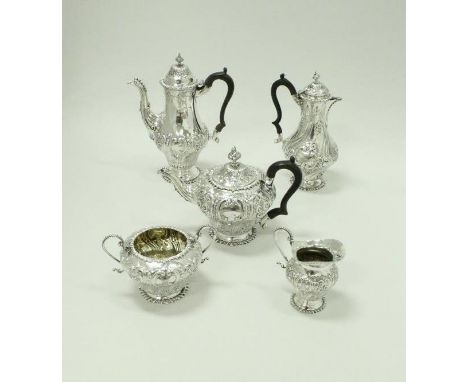 An Edwardian silver four piece tea set comprising teapot, coffee pot, twin handled sucrier and milk jug, all with heavy C scr