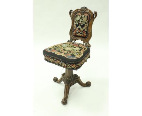 A 19th Century rosewood framed swivel chair with shell carving motif to the top rail above the needlework upholstered back an