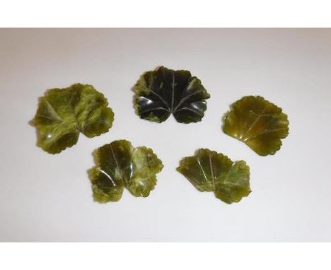 A collection of five carved jade leaves of varying sizes ranging from 3.5 cm - 4 cm