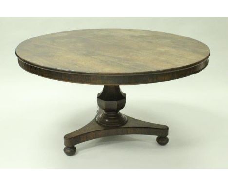 A 19th Century rosewood tilt-top breakfast table with plain frieze over a faceted baluster support to platform tripod base, o