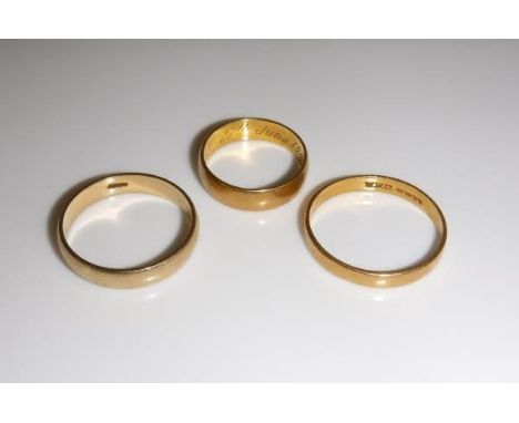 Two 22 carat gold wedding bands, together with a further gold wedding band, approx 9.4 g CONDITION REPORTS All have wear and 