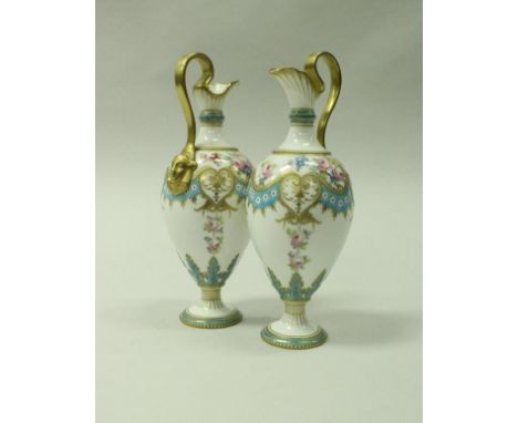 A pair of Royal Crown Derby cabinet ewers with gilded floral spray and turquoise banded decoration, raised on a circular foot