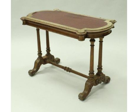 A Victorian walnut writing table by C Hindley & Sons, the inset writing surface with a shaped top and single frieze drawer st