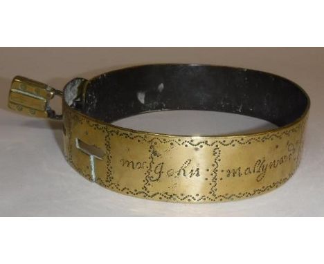 A 17th Century brass dog collar marked "Mr John Mallyward of.... 1687", 13 cm diameter CONDITION REPORTS There is no key and 