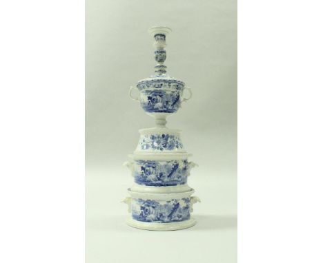 A 19th Century blue transfer decorated pottery table centre in five graduated sections, the upper section as a candlestick ov